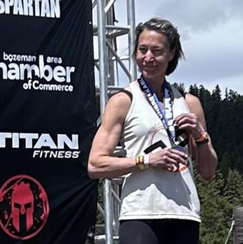 Michelle Schutte standing on Spartan Podium